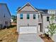 Two-story home boasts a painted brick facade, attached garage, and tidy landscaping under a clear blue sky at 1257 Fern Ridge Ct # 20, Norcross, GA 30093