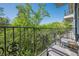 Balcony with cast-iron railings, seating, and views of lush green trees and blue skies at 3203 Lenox Ne Rd # 32, Atlanta, GA 30324