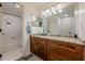 Bathroom features a double sink with granite countertops and a shower with white tile at 3203 Lenox Ne Rd # 32, Atlanta, GA 30324