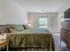 Bright bedroom featuring generous natural light, a closet, and a door leading to the balcony at 3203 Lenox Ne Rd # 32, Atlanta, GA 30324