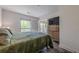 Comfortable bedroom featuring generous natural light, dresser, and a door leading to the balcony at 3203 Lenox Ne Rd # 32, Atlanta, GA 30324