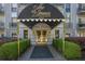 Elegant condo entrance with a black awning, manicured landscaping, and upscale finishes at 3203 Lenox Ne Rd # 32, Atlanta, GA 30324