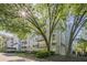 Low angle of condo building with mature trees, landscaping and private balconies at 3203 Lenox Ne Rd # 32, Atlanta, GA 30324