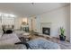 Spacious living room with an open floor plan showing the kitchen, dining area, fireplace and modern decor at 3203 Lenox Ne Rd # 32, Atlanta, GA 30324