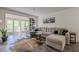 Cozy living room featuring a large sectional sofa, balcony access, and a decorative rug at 3203 Lenox Ne Rd # 32, Atlanta, GA 30324