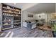 Spacious living room featuring a custom bookcase, neutral décor, and seamlessly flows to dining area at 3203 Lenox Ne Rd # 32, Atlanta, GA 30324