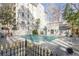 Relaxing outdoor pool area offering lounge chairs, iron fence and beautiful landscaping at 3203 Lenox Ne Rd # 32, Atlanta, GA 30324