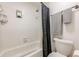 Bathroom shower and commode with white subway tile surround and a modern gray shower curtain at 3203 Lenox Ne Rd # 32, Atlanta, GA 30324