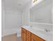 Bathroom featuring double sinks, wood cabinetry, bathtub with shower, and large vanity mirror at 3447 Dogwood Pass, Lithonia, GA 30038