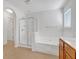 Bright bathroom with a shower, soaking tub and tile flooring at 3447 Dogwood Pass, Lithonia, GA 30038