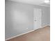Bedroom with neutral paint, carpet and a white door, offering a calm and inviting space at 3447 Dogwood Pass, Lithonia, GA 30038