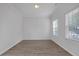 Neutral bedroom with wood-look floors, white walls, and large windows for natural light at 3447 Dogwood Pass, Lithonia, GA 30038