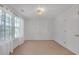 A spacious and well-lit bedroom featuring a large window and light fixture, creating a welcoming atmosphere at 3447 Dogwood Pass, Lithonia, GA 30038