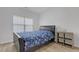 Bedroom featuring a bed, side table, a large window, and wood-look flooring at 3447 Dogwood Pass, Lithonia, GA 30038