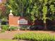 The Parks of Stonecrest sign with brick wall, landscaping and pink flowers at 3447 Dogwood Pass, Lithonia, GA 30038