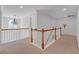Upstairs hallway featuring a chandelier, and white wooden railing at 3447 Dogwood Pass, Lithonia, GA 30038