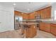 Modern kitchen featuring wood cabinets, stainless steel appliances, and a center island with barstool seating at 3447 Dogwood Pass, Lithonia, GA 30038