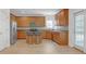 Spacious kitchen featuring stainless steel appliances, wood cabinets, tile backsplash, and an island with seating at 3447 Dogwood Pass, Lithonia, GA 30038