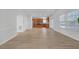 Open-concept living room with modern wood floors, stainless steel appliances and lots of natural light at 3447 Dogwood Pass, Lithonia, GA 30038
