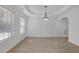 Spacious living room with light-colored floors, wainscoting, and a decorative ceiling at 3447 Dogwood Pass, Lithonia, GA 30038