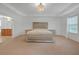 Elegant main bedroom with tray ceiling, en suite bathroom, and luxurious bed with matching furniture at 3447 Dogwood Pass, Lithonia, GA 30038