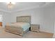 Main bedroom features tray ceiling, decorative chandelier and upholstered headboard at 3447 Dogwood Pass, Lithonia, GA 30038