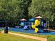 Brightly colored community playground with swings, slides and other play equipment at 3447 Dogwood Pass, Lithonia, GA 30038