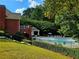 A fenced community pool with lounge chairs and a seating area at 3447 Dogwood Pass, Lithonia, GA 30038