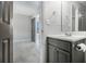 View of a gray vanity with granite countertop, mirror and bathroom decor at 89 Bridge View Dr, Marietta, GA 30066