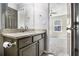 Well-lit bathroom with gray vanity, granite countertop, and mirrored wall at 89 Bridge View Dr, Marietta, GA 30066