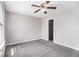 Carpeted bedroom featuring a ceiling fan, neutral paint, and ample natural light at 89 Bridge View Dr, Marietta, GA 30066