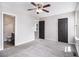 Bright bedroom featuring plush carpet, ceiling fan, and ensuite bathroom access at 89 Bridge View Dr, Marietta, GA 30066