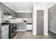 Modern kitchen featuring stainless steel appliances, granite countertops, and vinyl flooring at 89 Bridge View Dr, Marietta, GA 30066