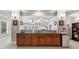 Finished basement bar with dark wood cabinetry, granite countertop, and adjacent seating at 1227 Magnolia Path Way, Sugar Hill, GA 30518