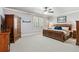 Bedroom featuring a large window, carpet flooring and dark wood furniture at 1227 Magnolia Path Way, Sugar Hill, GA 30518