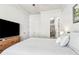 Bright bedroom with comfortable queen bed, large windows and TV at 1227 Magnolia Path Way, Sugar Hill, GA 30518
