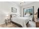 Neutral bedroom with comfortable queen bed, window and furnishings at 1227 Magnolia Path Way, Sugar Hill, GA 30518