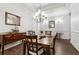 Formal dining room featuring hardwood floors, wainscoting, and an elegant chandelier at 1227 Magnolia Path Way, Sugar Hill, GA 30518