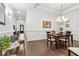 Open dining room with hardwood floors, wainscoting, and adjacent sitting area at 1227 Magnolia Path Way, Sugar Hill, GA 30518