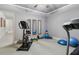 Spacious exercise room equipped with an exercise bike, treadmill, and workout equipment at 1227 Magnolia Path Way, Sugar Hill, GA 30518