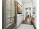 Elegant foyer with hardwood floors, decorative glass door, white walls and an artful painting at 1227 Magnolia Path Way, Sugar Hill, GA 30518