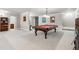 Spacious carpeted game room including a pool table, neutral walls, and accent lighting at 1227 Magnolia Path Way, Sugar Hill, GA 30518