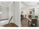 Open hallway showcasing hardwood floors, detailed trim, and views to dining and kitchen at 1227 Magnolia Path Way, Sugar Hill, GA 30518
