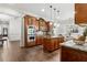 Bright kitchen featuring an island, wooden cabinets, granite countertops, and stainless steel appliances at 1227 Magnolia Path Way, Sugar Hill, GA 30518