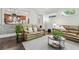 Comfortable living room with wood floors open to the modern kitchen at 1227 Magnolia Path Way, Sugar Hill, GA 30518