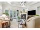 Inviting living room with coffered ceiling, fireplace, and access to the outdoors through French doors at 1227 Magnolia Path Way, Sugar Hill, GA 30518