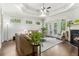 Open living room with trey ceilings, hardwood floors, fireplace and backyard view at 1227 Magnolia Path Way, Sugar Hill, GA 30518