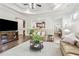 Spacious living room with dark wood floors that connects to the kitchen and dining room at 1227 Magnolia Path Way, Sugar Hill, GA 30518