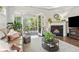 Cozy living room featuring a fireplace, view of the outdoors and comfortable seating at 1227 Magnolia Path Way, Sugar Hill, GA 30518