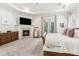 Large main bedroom suite with fireplace, TV, and balcony at 1227 Magnolia Path Way, Sugar Hill, GA 30518